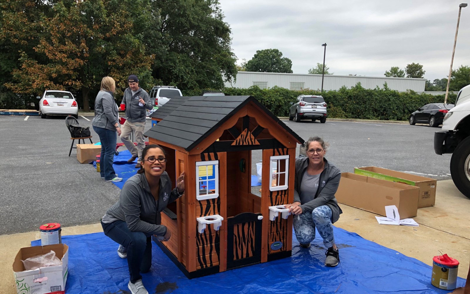 Volunteers construct and paint children’s playhouses that are donated to local Habitat families
