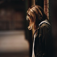 Girl standing against a wall