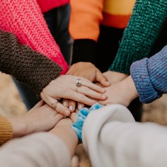 Hands piled together