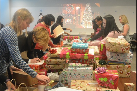 Employees wrapping gifts for United Way of Central Maryland